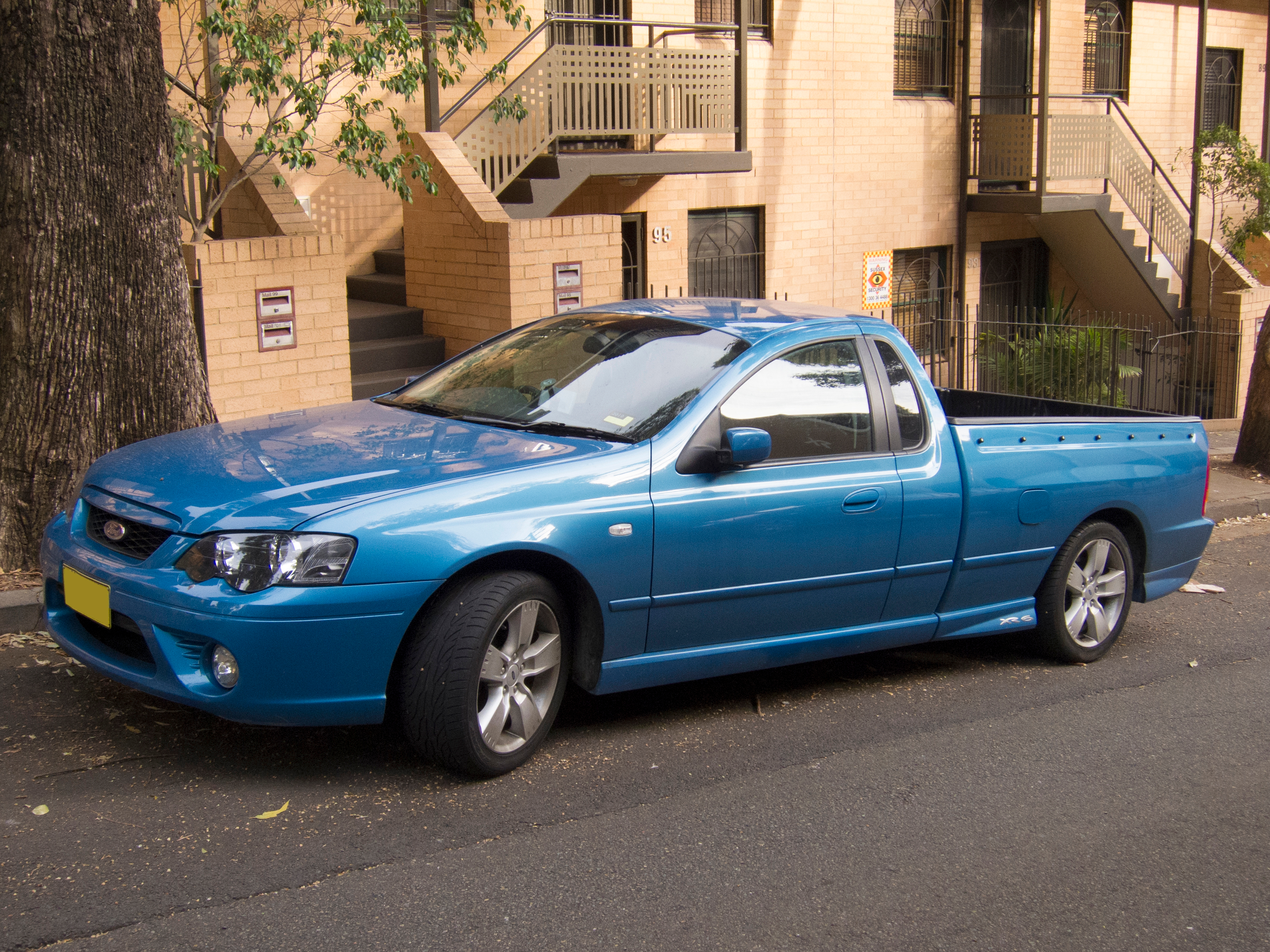Blue holden ute parked on road