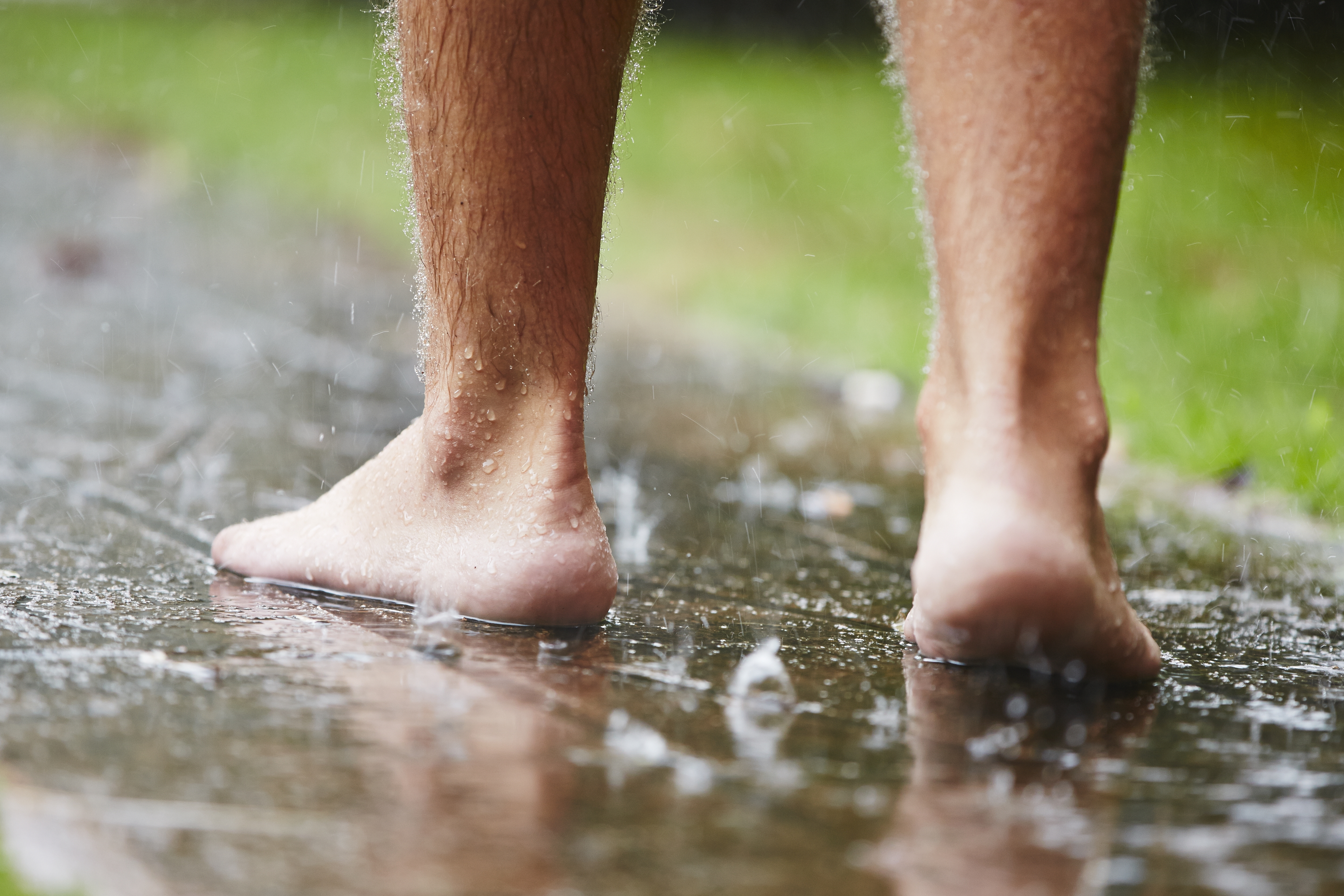 Man walking in rain without shoes