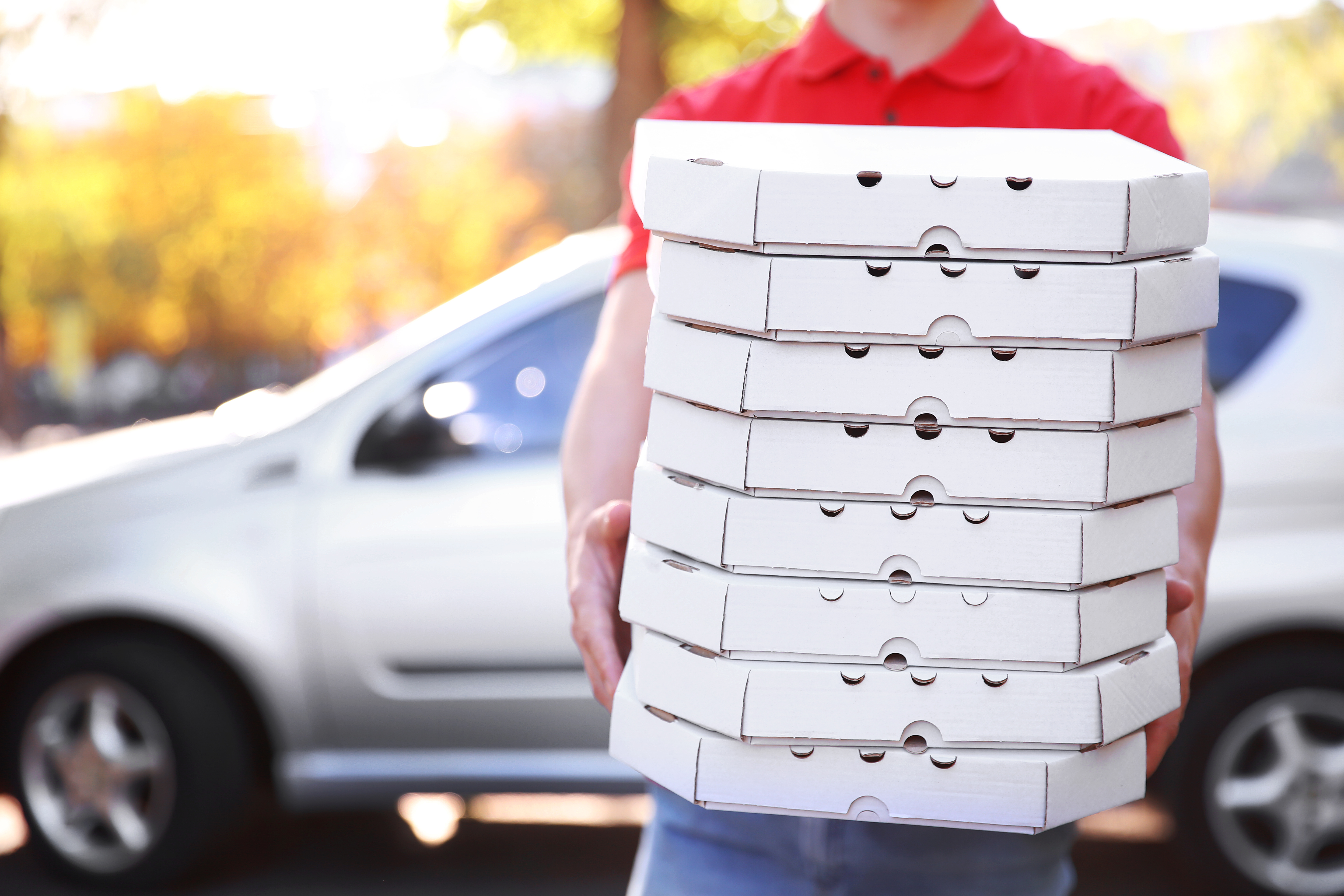 Pizza delivery man holding pizza