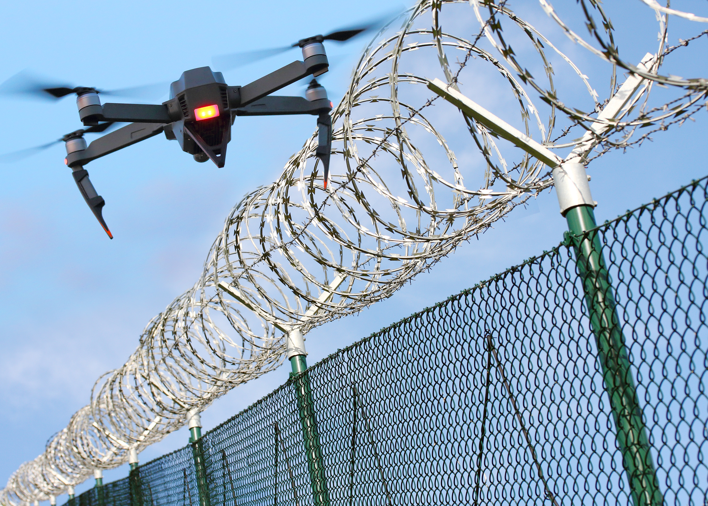 Drone flying over jail fence to smuggle contraband