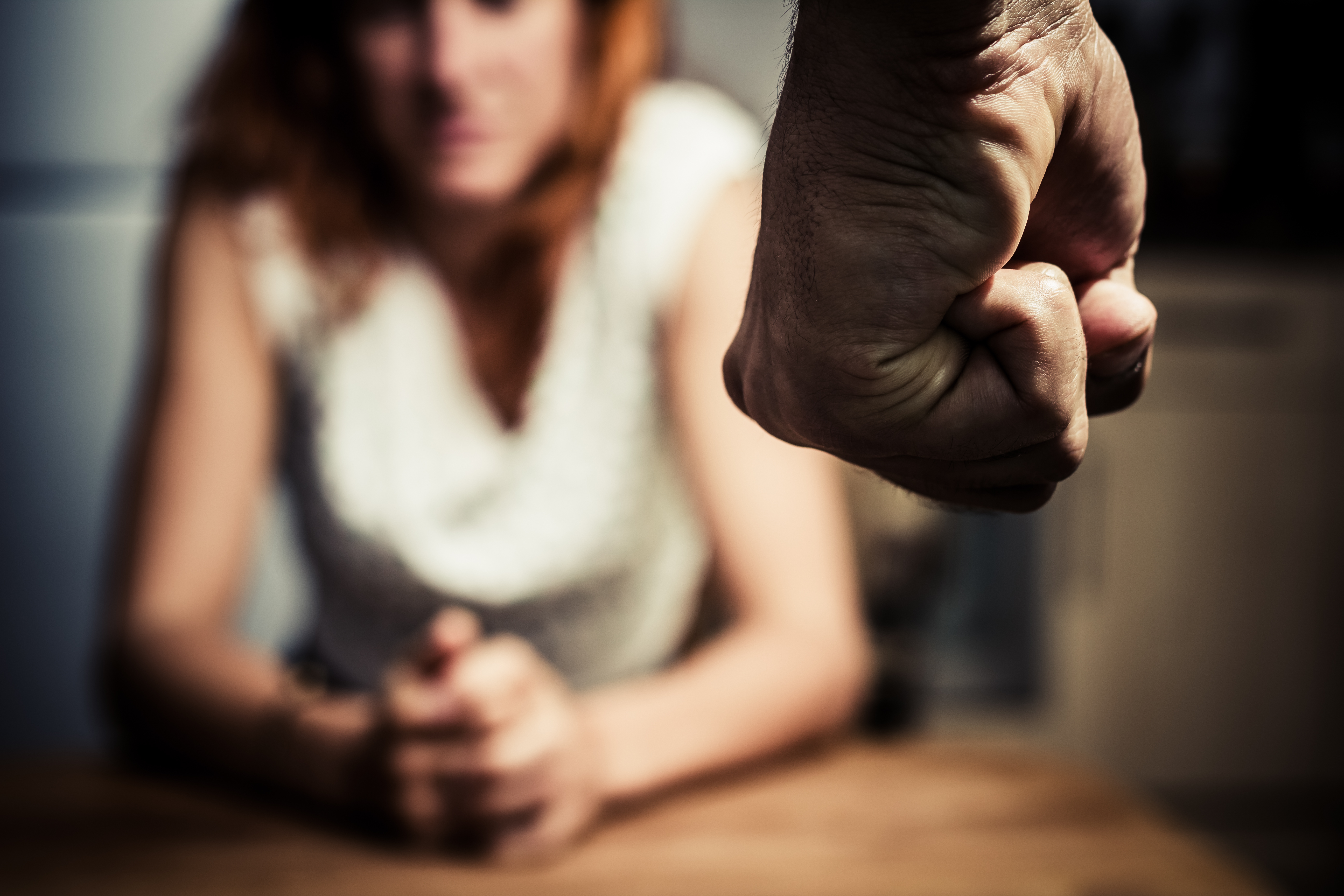 Man with fist clenched to assault partner in domestic violence